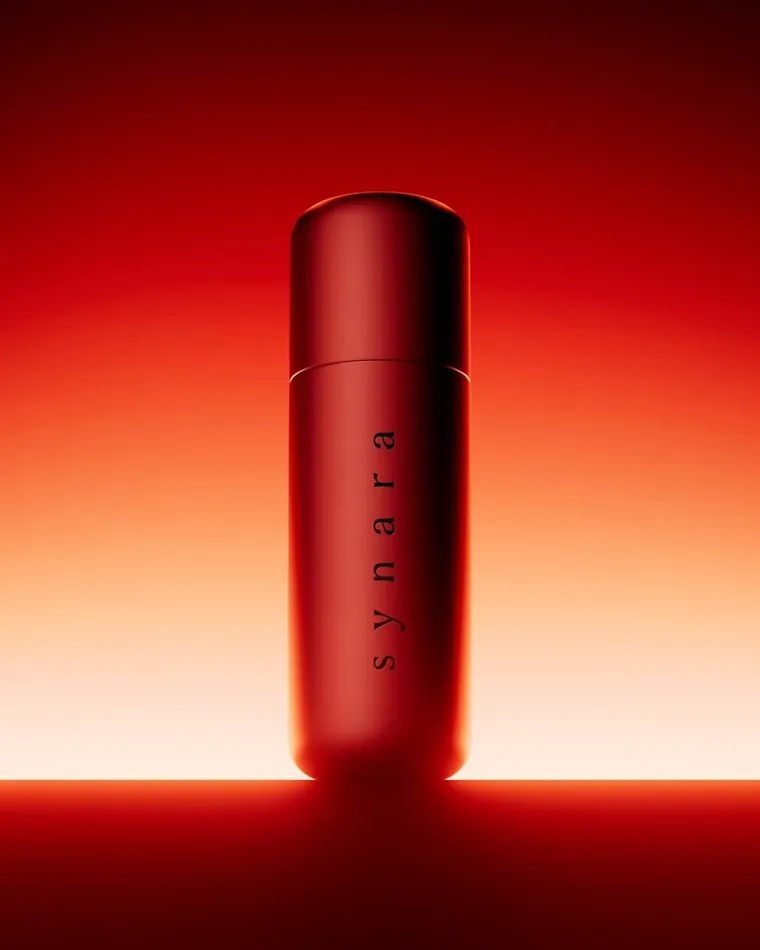 Red cosmetic product against a warm red backdrop
