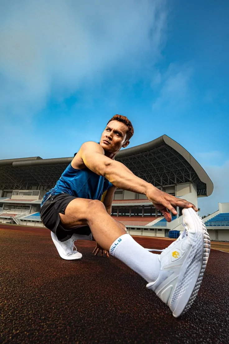 Athlete stretching on a running track before training